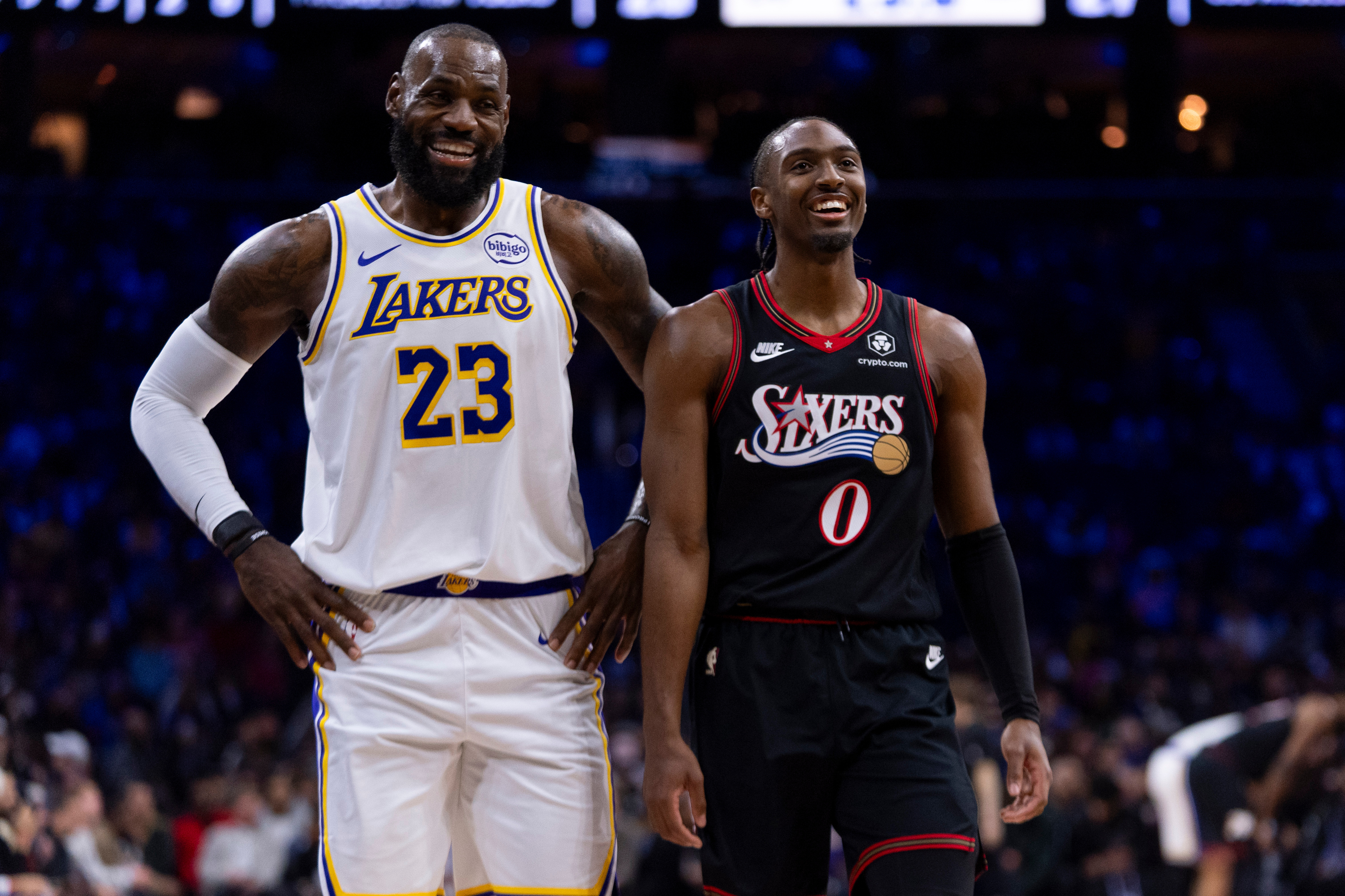 Los Angeles Lakers' LeBron James, left, talks with Philadelphia 76ers' Tyrese Maxey, right, during the first half of an NBA basketball game, Sunday, Dec. 7, 2025, in Philadelphia.