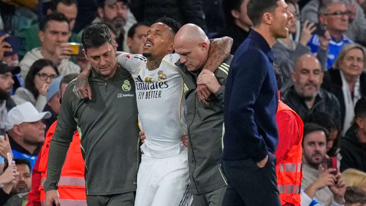 Real Madrid's Eder Militao is assisted from the pitch after getting an injury during the Spanish La Liga soccer match between Real Madrid and Celta Vigo in Madrid, Spain, Sunday, Dec. 7, 2025.