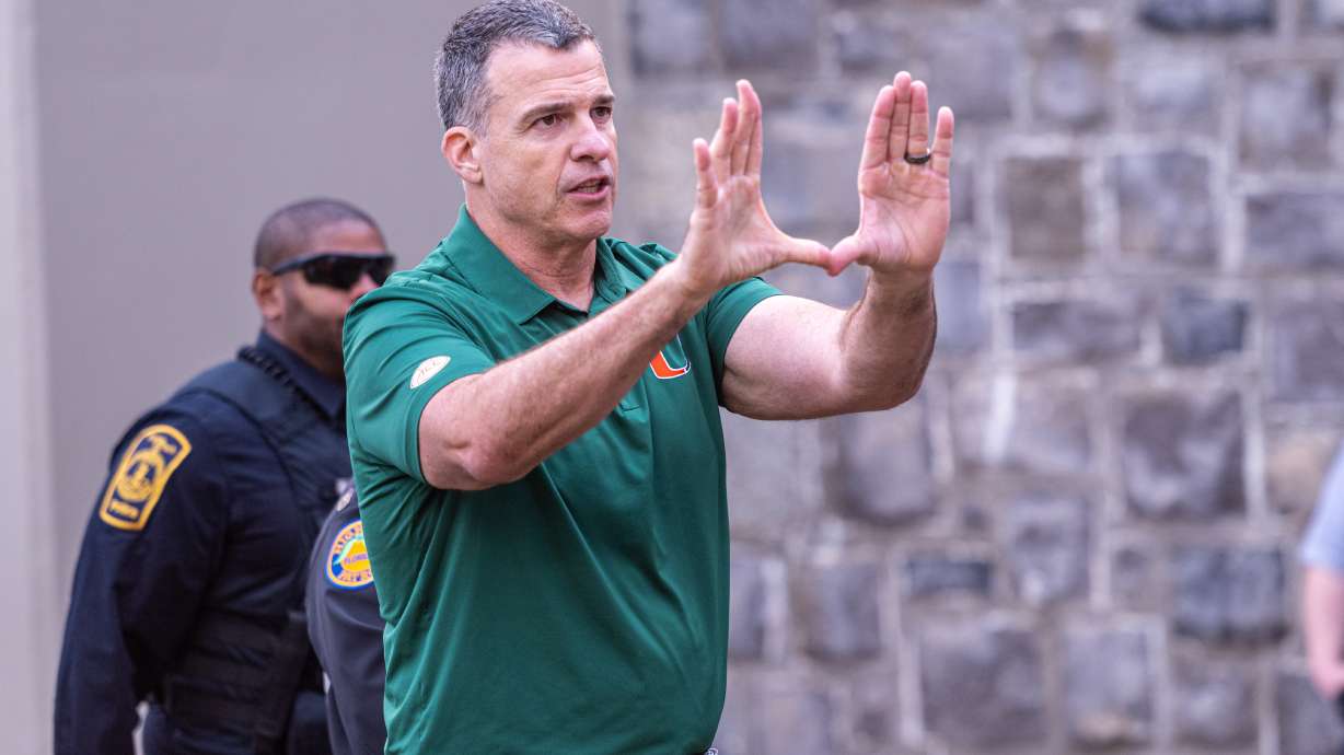 Miami head coach Mario Cristobal gestures towards the fans after defeating Virginia Tech in an NCAA college football game, Saturday, Nov. 22, 2025, in Blacksburg, Va.