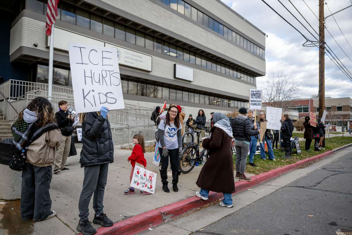 Protesters gather in front of the U.S. Citizenship and Immigration Services field office in Salt Lake City on Monday.