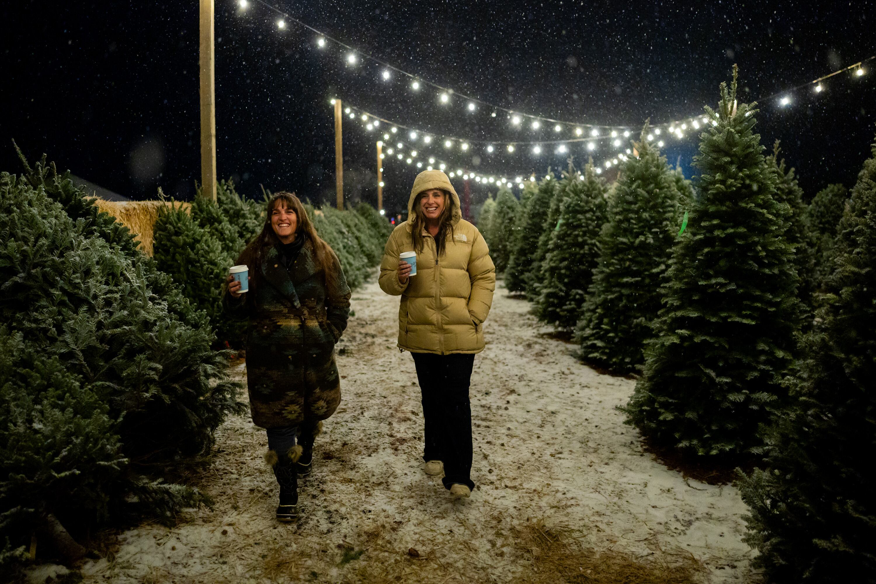 Cyndee Burnham, left, and Laurel Oakeson, right, attend Ballerina Farm’s tree lighting ceremony at their winter market in Kamas on Dec. 5.