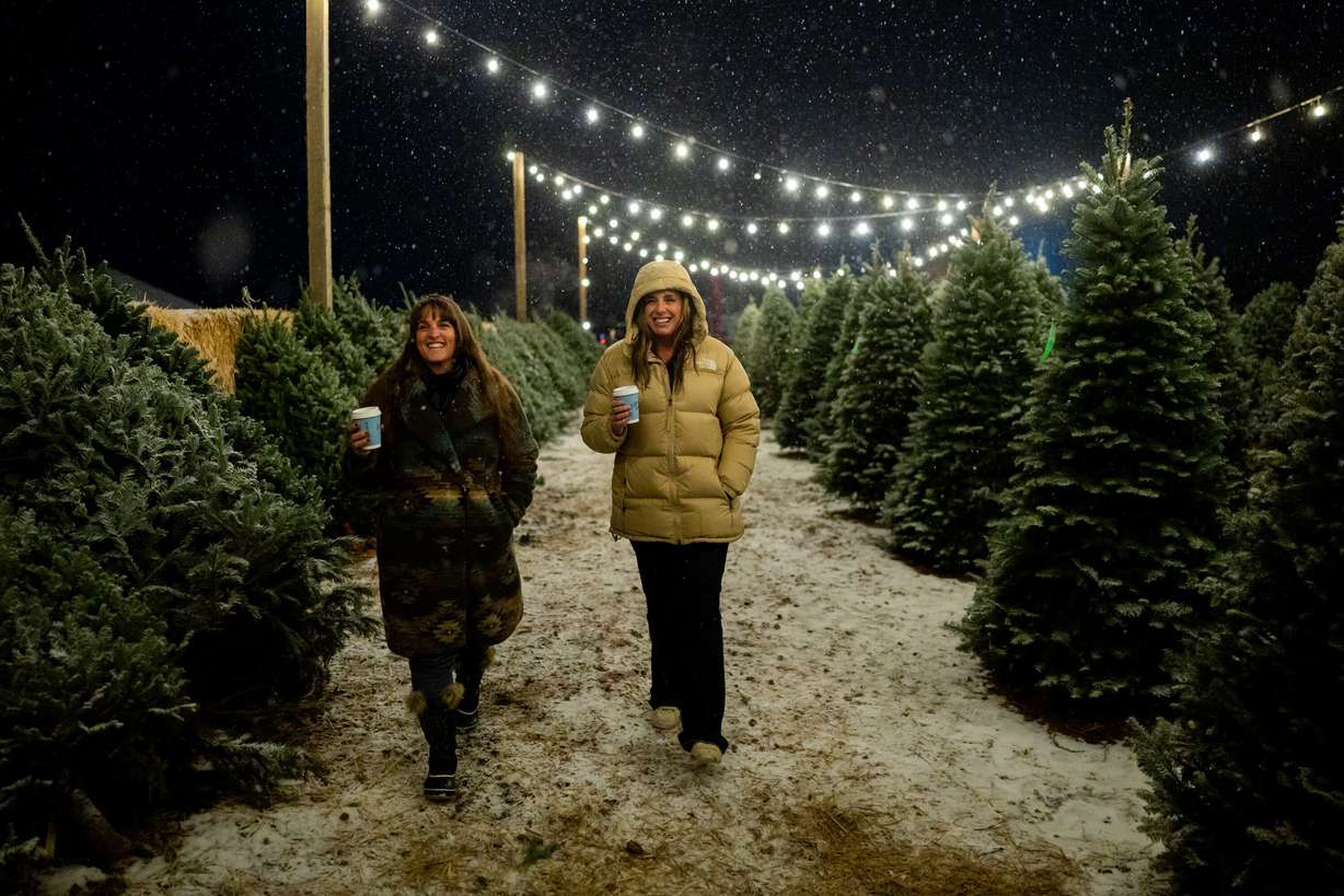 Cyndee Burnham, left, and Laurel Oakeson, right, attend Ballerina Farm’s tree lighting ceremony at their winter market in Kamas on Dec. 5.