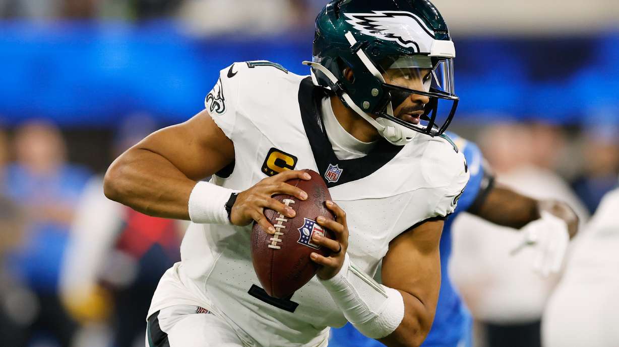 Philadelphia Eagles quarterback Jalen Hurts (1) rolls out during the second half of an NFL football game against the Los Angeles Chargers, Monday, Dec. 8, 2025, in Inglewood, Calif.