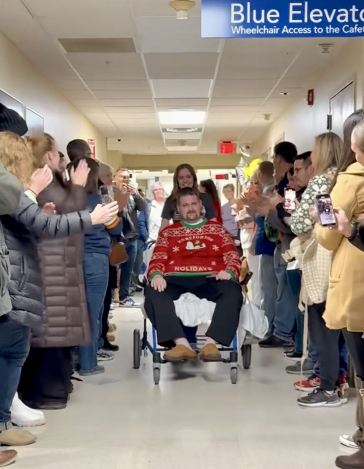 Benjamin Phelps is greeted by family members and friends as he leaves the hospital on Friday. Phelps was wounded in the attack on a Church of Jesus Christ meetinghouse in Michigan on Sept. 28.