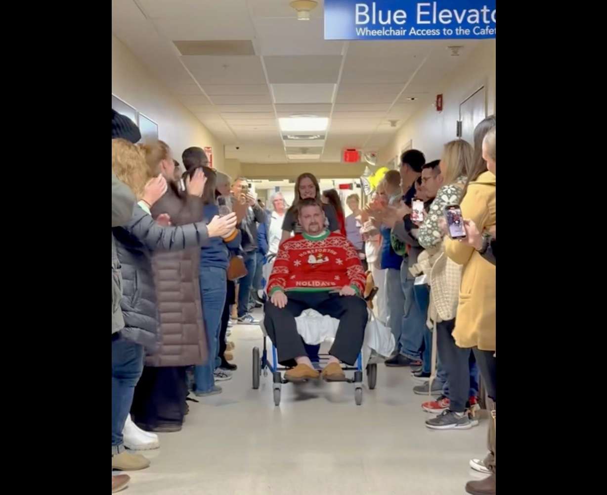 Benjamin Phelps is greeted by family members and friends as he leaves the hospital on Friday. Phelps was wounded in the attack on a Church of Jesus Christ meetinghouse in Michigan on Sept. 28.