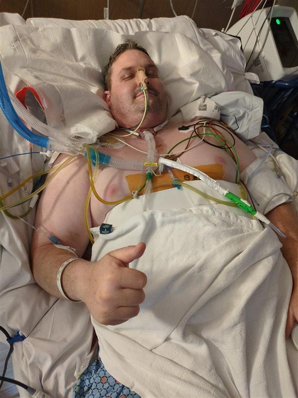 Benjamin Phelps in the hospital. Phelps, who was wounded in the Sept. 28 attack on a Church of Jesus Christ meetinghouse in Michigan, endured 25 surgeries.