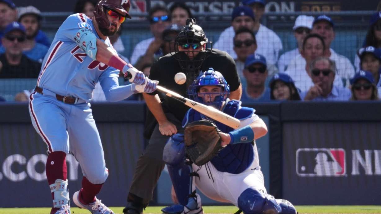 FILE - Philadelphia Phillies' Kyle Schwarber connects for a double during the first inning in Game 4 of baseball's National League Division Series against the Los Angeles Dodgers, Oct. 9, 2025, in Los Angeles.