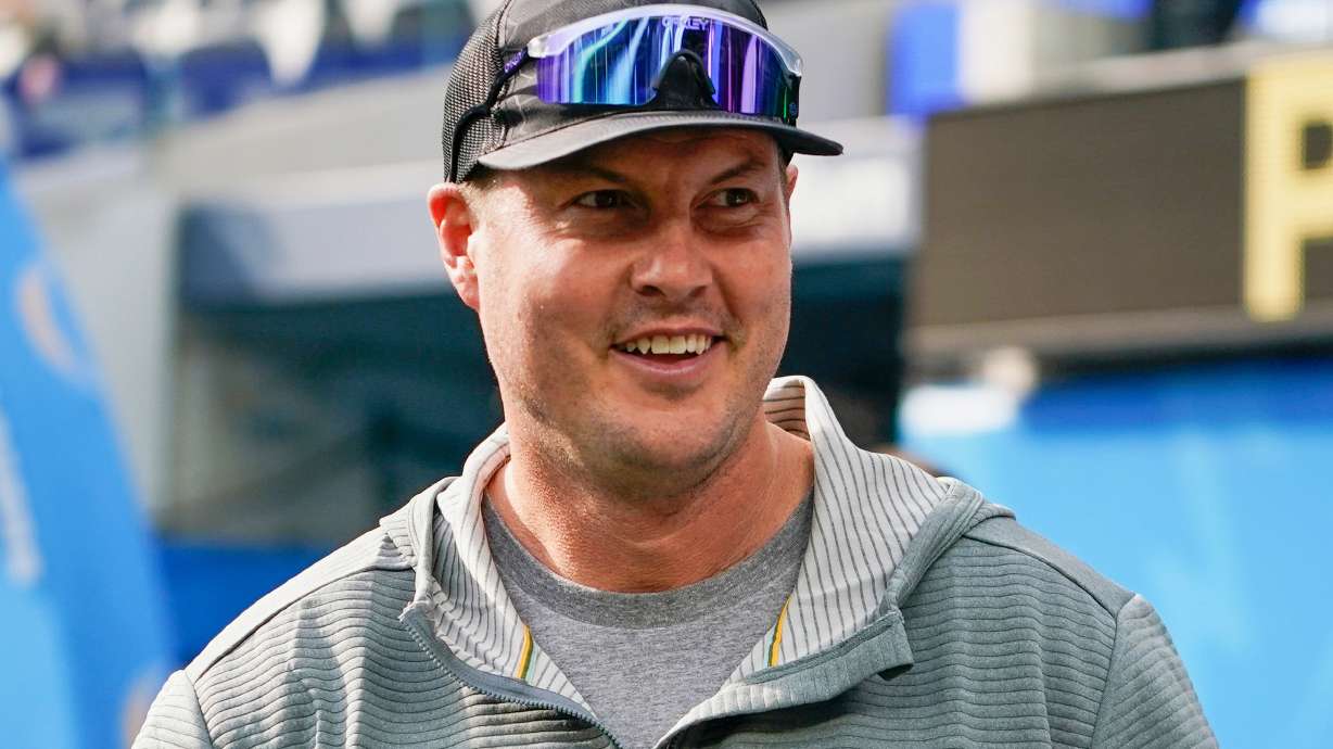 FILE - Former Los Angeles Chargers quarterback Philip Rivers watches warmups before an NFL football game between the Chargers and the Denver Broncos, Dec. 10, 2023, in Inglewood, Calif.