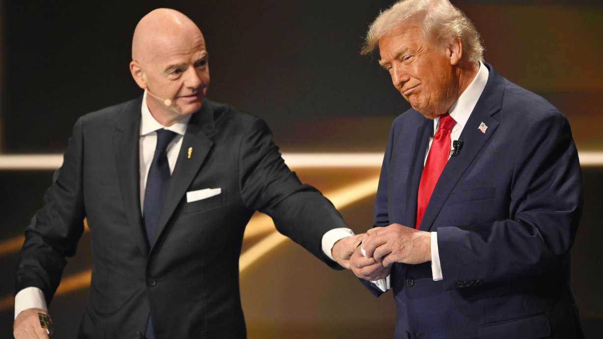 FIFA President Gianni Infantino pauses President Donald Trump during the draw for the 2026 soccer World Cup at the Kennedy Center in Washington, Friday, Dec. 5, 2025.