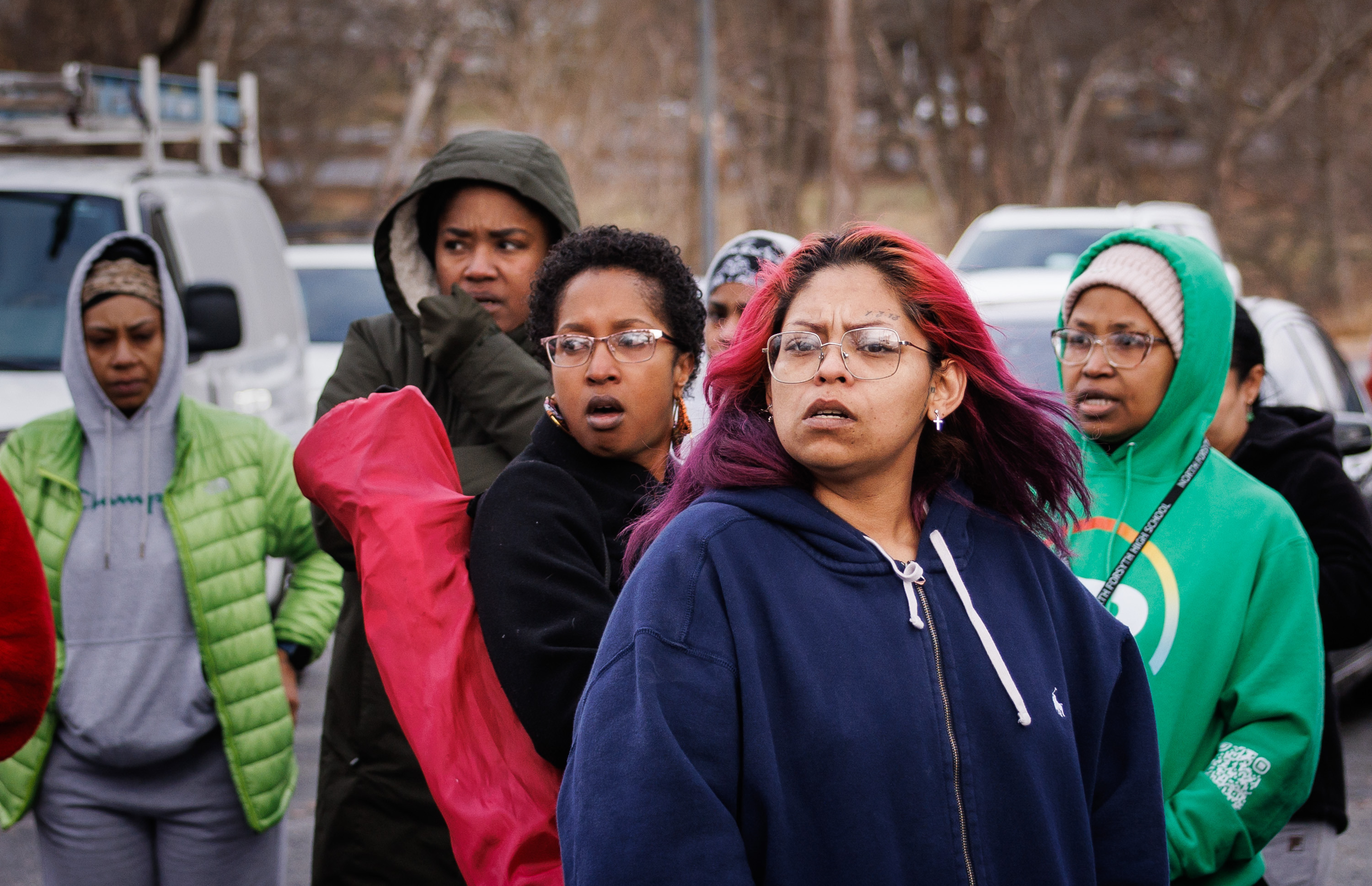 Family members and friends of North Forsyth High School students wait in a parking lot across the street from the school after a fatal stabbing, Tuesday, in Winston-Salem, N.C. One student died and another was injured, authorities said.