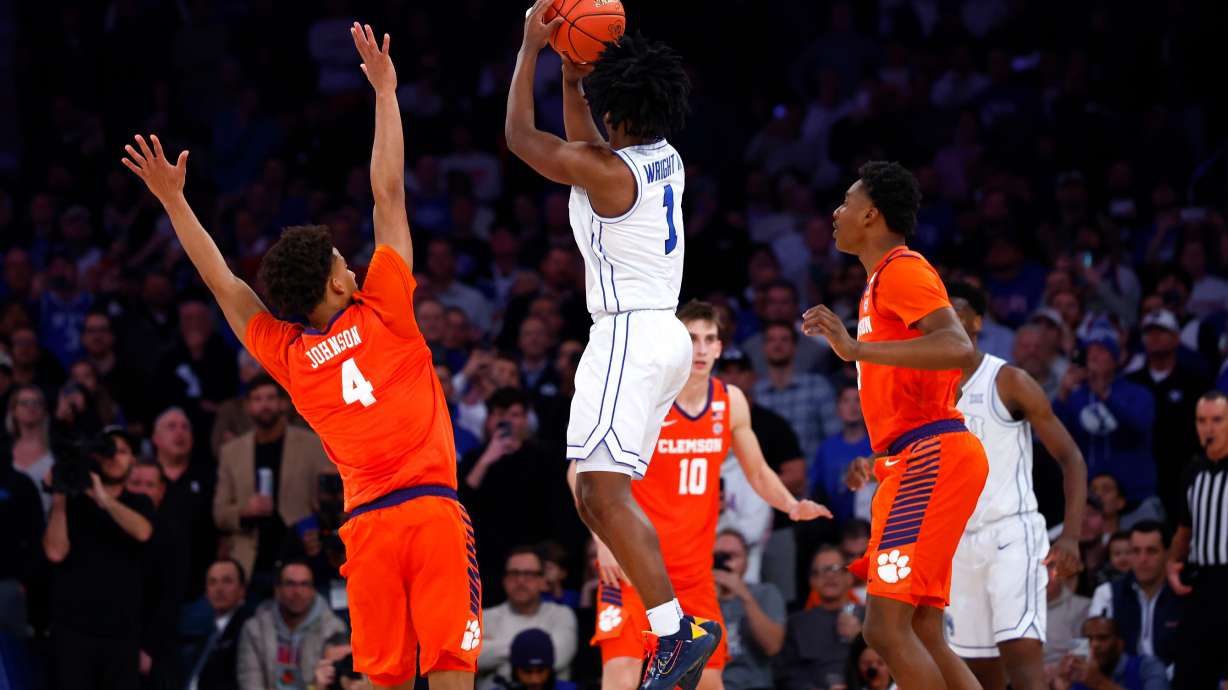 BYU guard Robert Wright III (1) makes the game winning shot against Clemson guard Efrem Johnson (4) during the second half of an NCAA basketball game, Tuesday, Dec. 9, 2025, in New York.