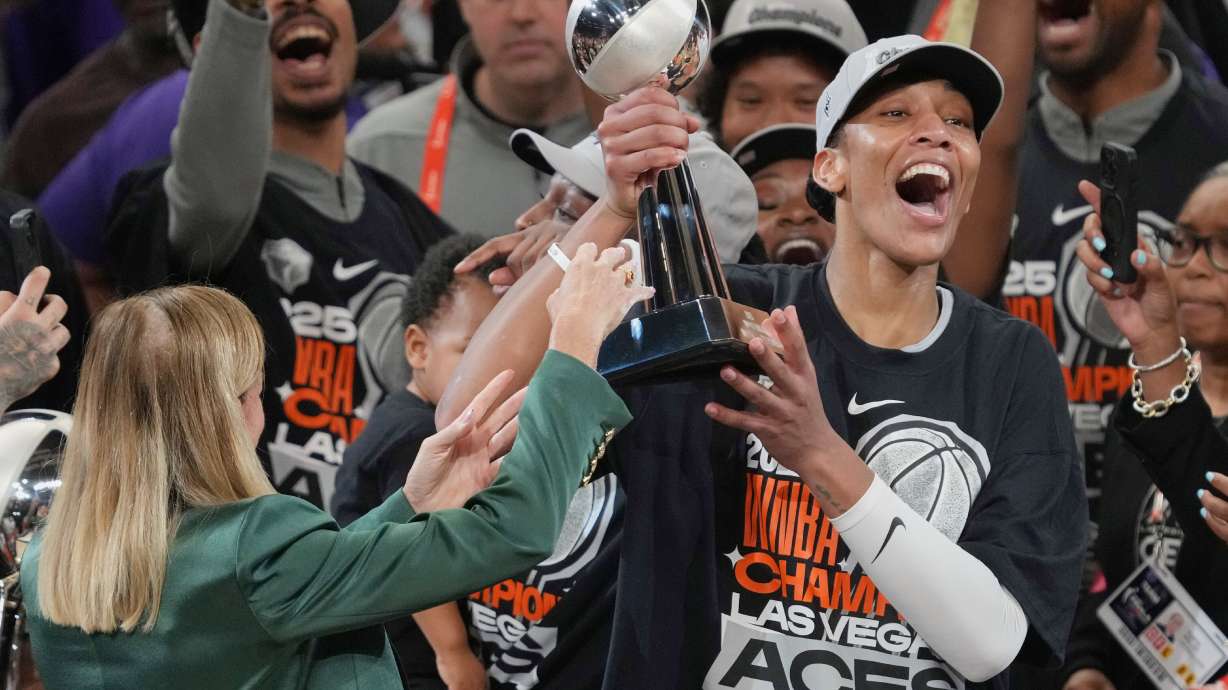 FILE - Las Vegas Aces center A'ja Wilson, center right, holds up her MVP trophy after Game 4 of the WNBA basketball finals against the Phoenix Mercury, Friday, Oct. 10, 2025, in Phoenix.