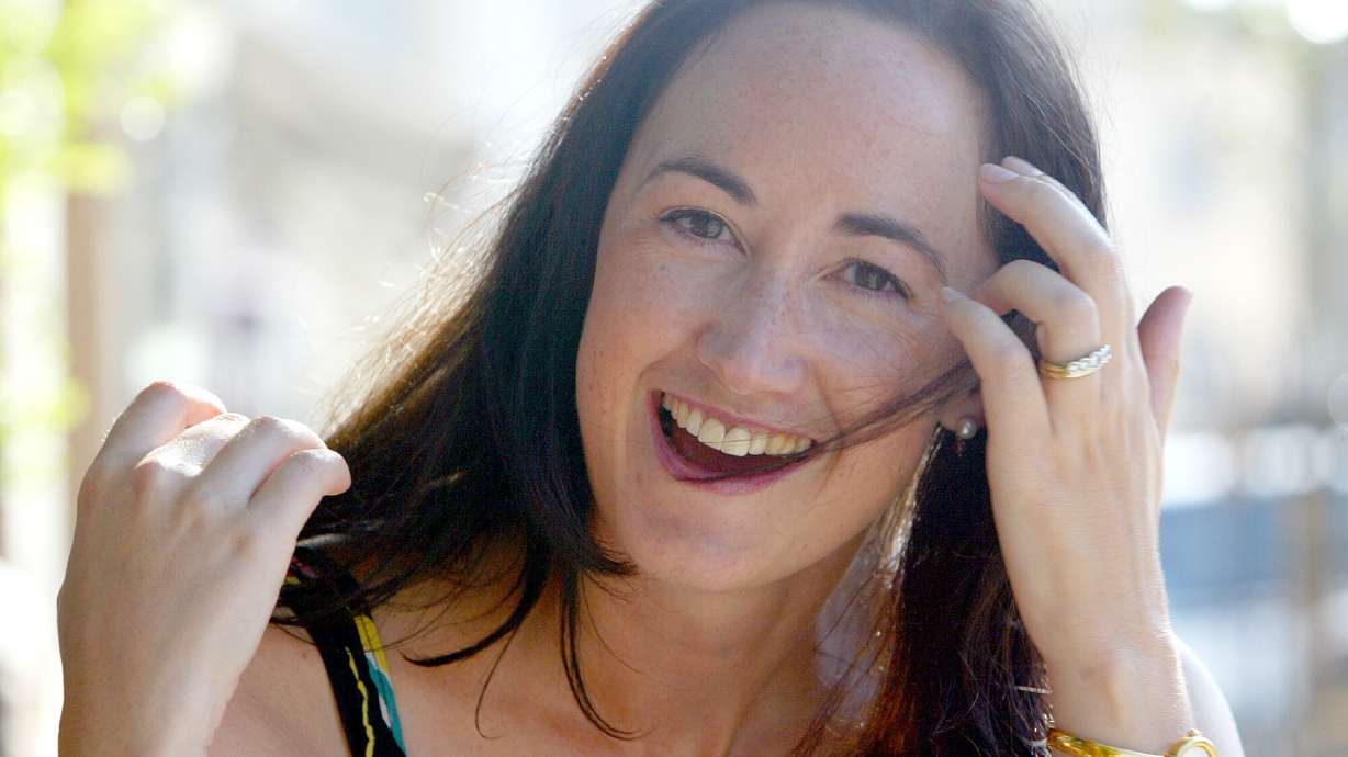 Author Sophie Kinsella poses on Wimbledon Village high street, London, Sept. 9, 2004.