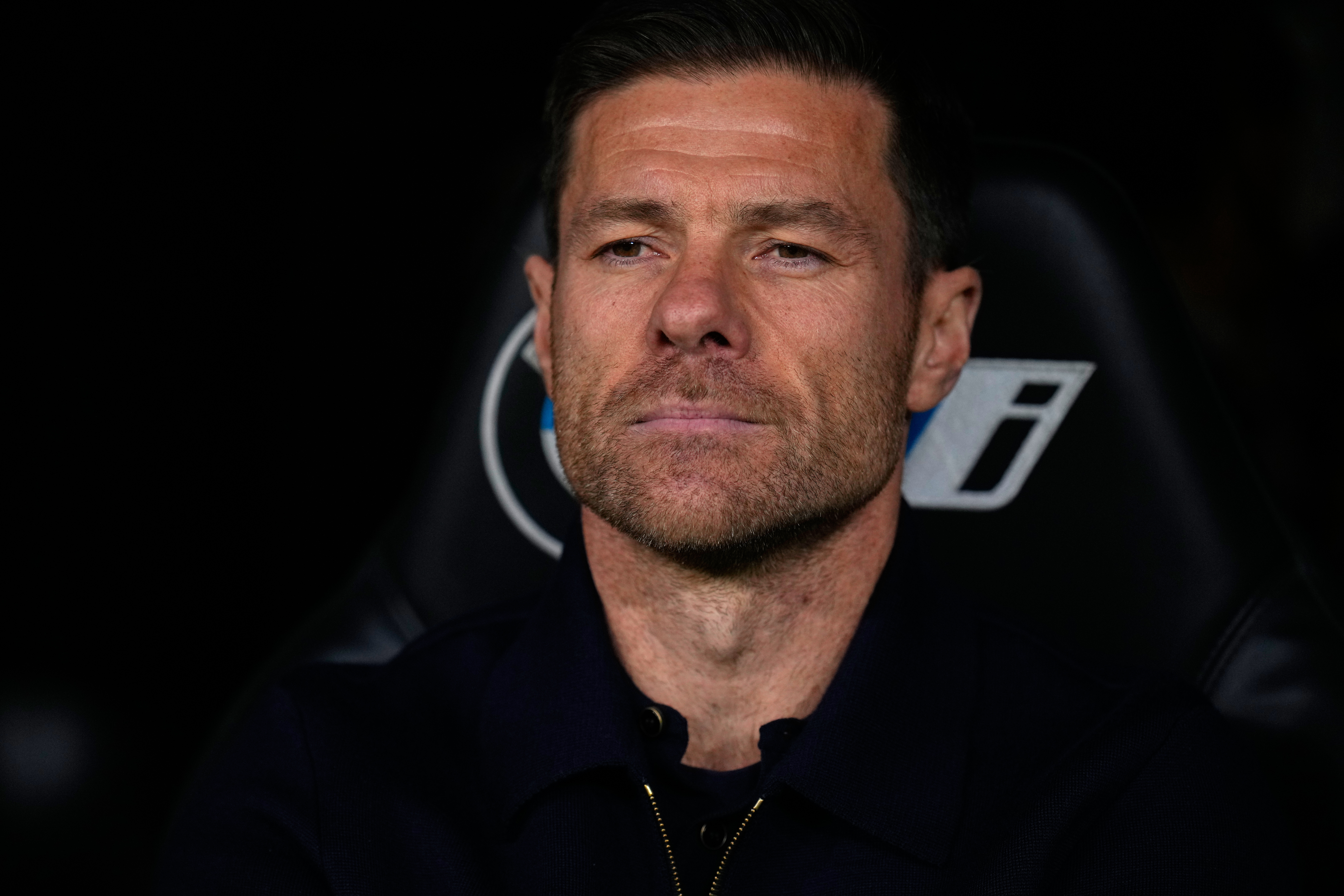 Real Madrid's head coach Xabi Alonso takes his seat on the bench before the Spanish La Liga soccer match between Real Madrid and Celta Vigo in Madrid, Spain, Sunday, Dec. 7, 2025.