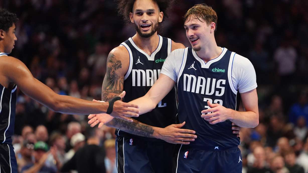 CORRECT PLAYER AT CENTER - Dallas Mavericks forward Cooper Flagg (32) celebrates with teammates guard Max Christie, left, and center Dereck Lively II (2) during the second half of an NBA basketball game against the New Orleans Pelicans in Dallas, Friday, Nov. 21, 2025.