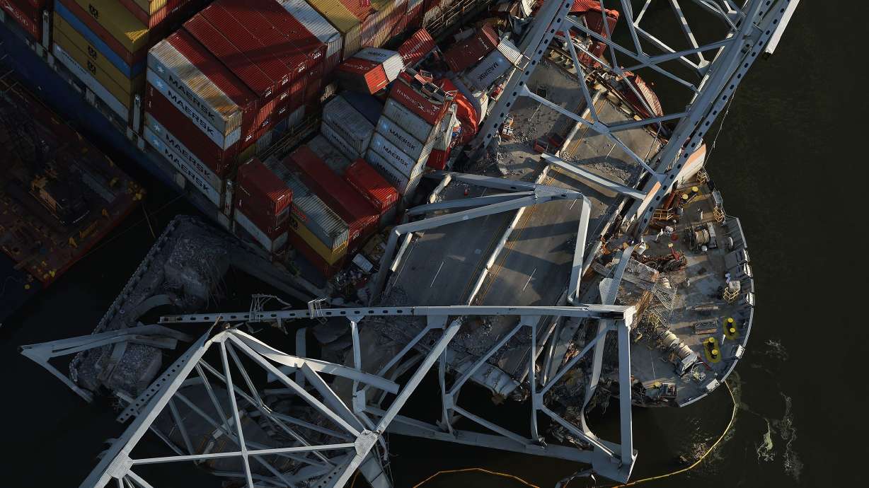 Salvage crews continue to remove wreckage from the cargo ship Dali after it struck the Francis Scott Key Bridge, as seen in April 2024 in Baltimore. A misplaced wire label and other mishaps likely contributed to the collapse, the NTSB said Wednesday.