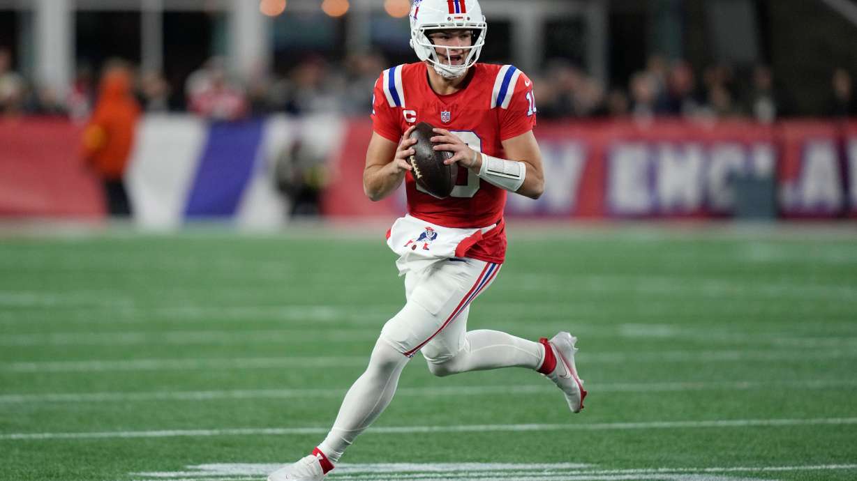 New England Patriots quarterback Drake Maye rolls out during the first half of an NFL football game against the New York Giants, Monday, Dec. 1, 2025, in Foxborough, Mass.