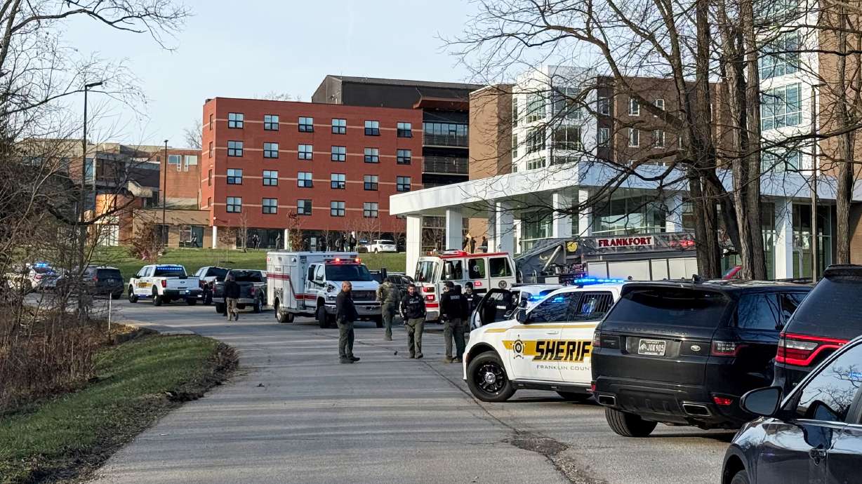Law enforcement responds to a shooting at Whitney Moore Young Jr. Hall on Kentucky State University's campus in Frankfort, Ky., Tuesday. A parent of a student at the school was charged with murder on Wednesday in connection to the shooting.