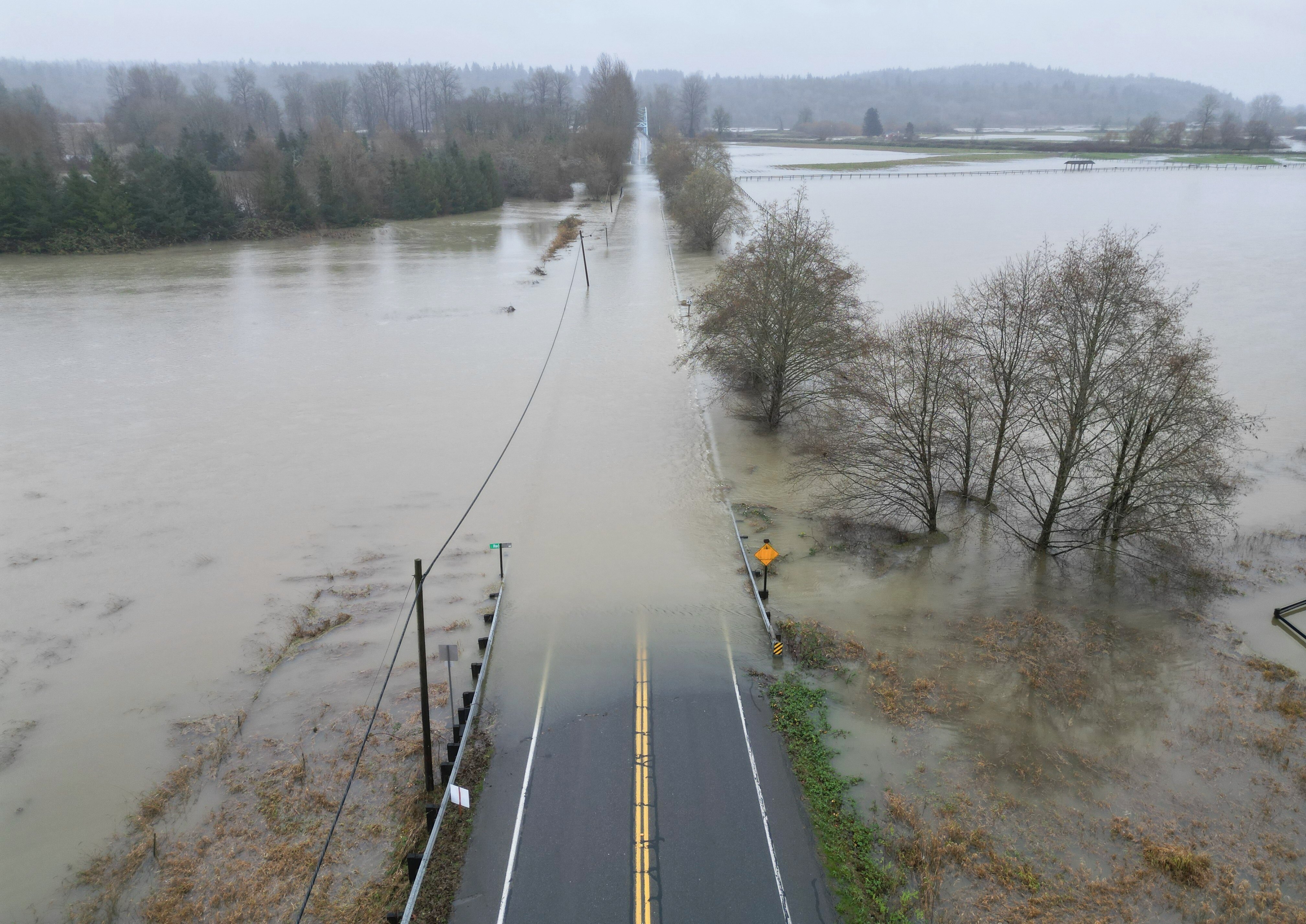 The flooding Snoqualmie River has closed NE 124th St., which connects W. Snoqualmie Valley Rd. NE on the Redmond side, and state Route 203 on the Duvall and Carnation side, Wednesday, near Novelty, Washington. The flood is part of warmer storms still impacting the West this week.