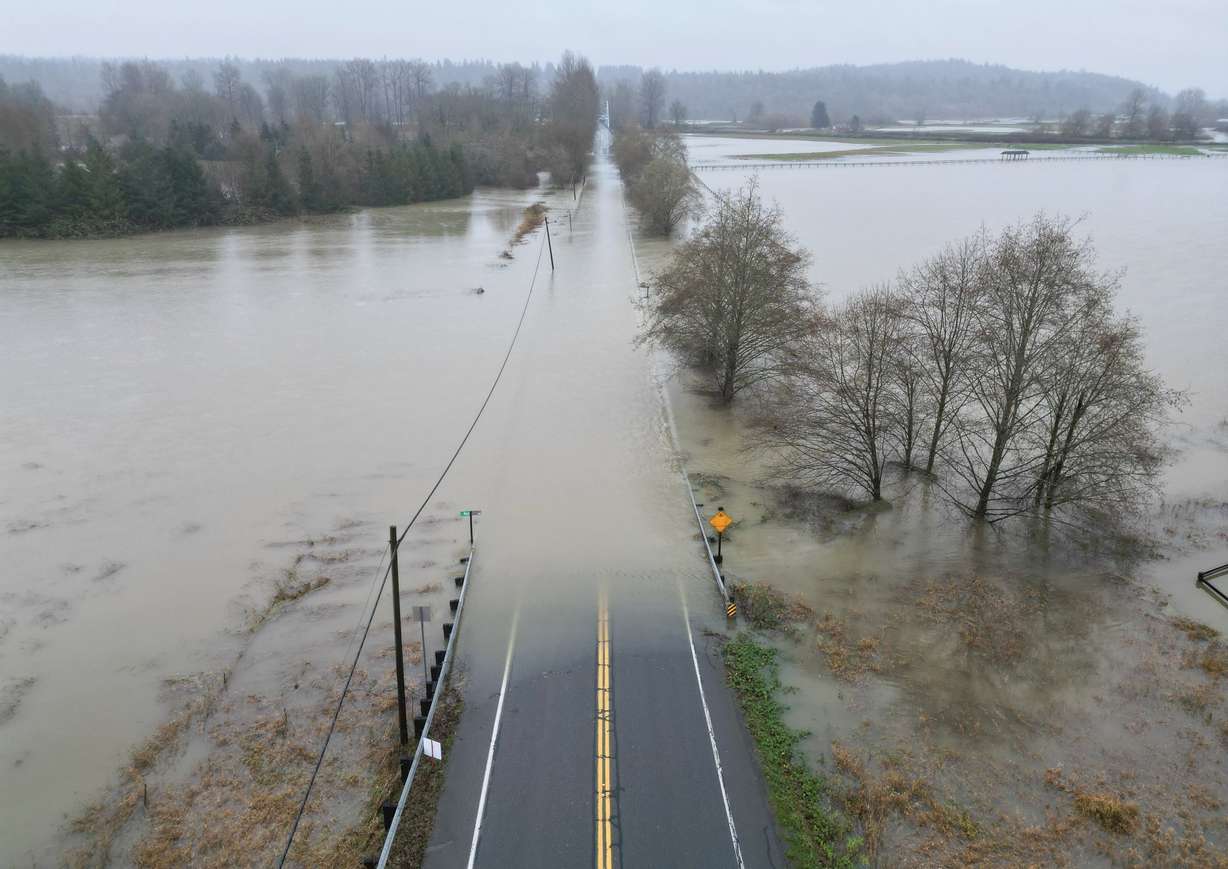 The flooding Snoqualmie River has closed NE 124th St., which connects W. Snoqualmie Valley Rd. NE on the Redmond side, and state Route 203 on the Duvall and Carnation side, Wednesday, near Novelty, Washington. The flood is part of warmer storms still impacting the West this week.