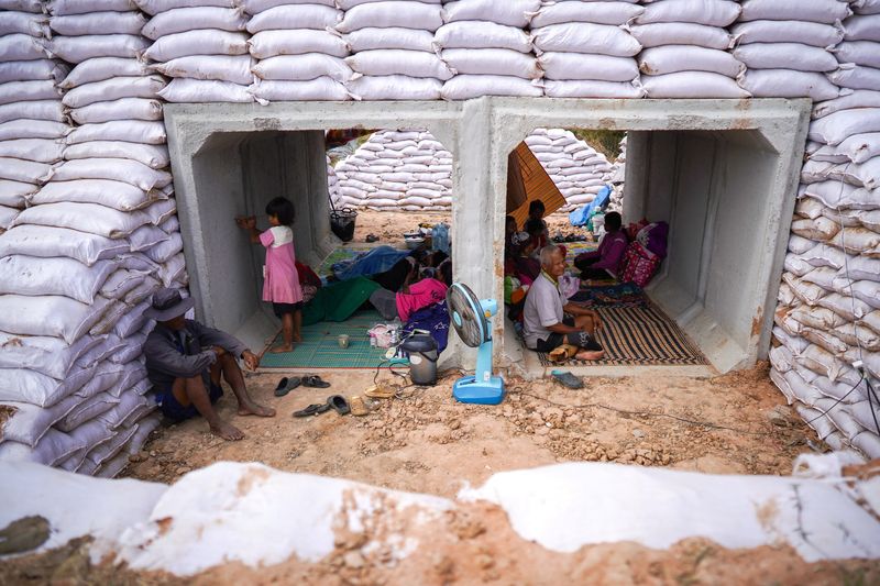 People take shelter inside a bunker amid deadly clashes between Thailand and Cambodia along a disputed border area in Sa Kaeo province, Thailand, Wednesday. The reignited conflict has killed 20 people and displaced thousands.