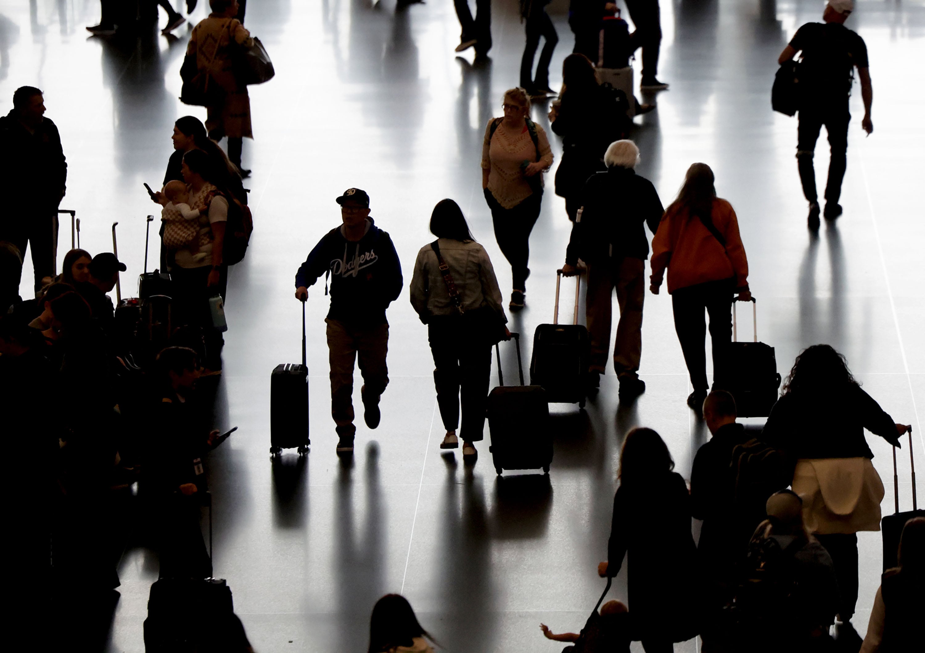 Travelers walk through the Salt Lake City International Airport on Oct. 16.