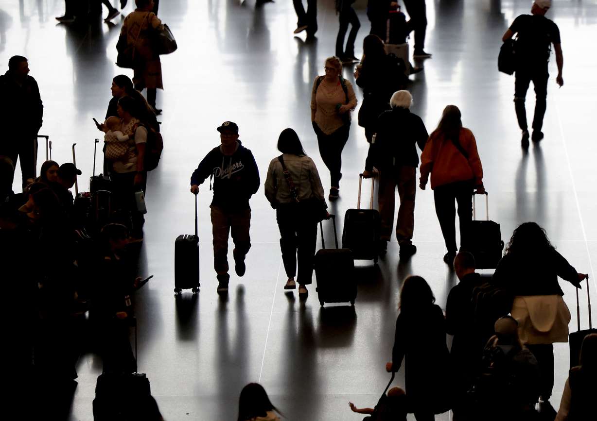 Travelers walk through the Salt Lake City International Airport on Oct. 16.