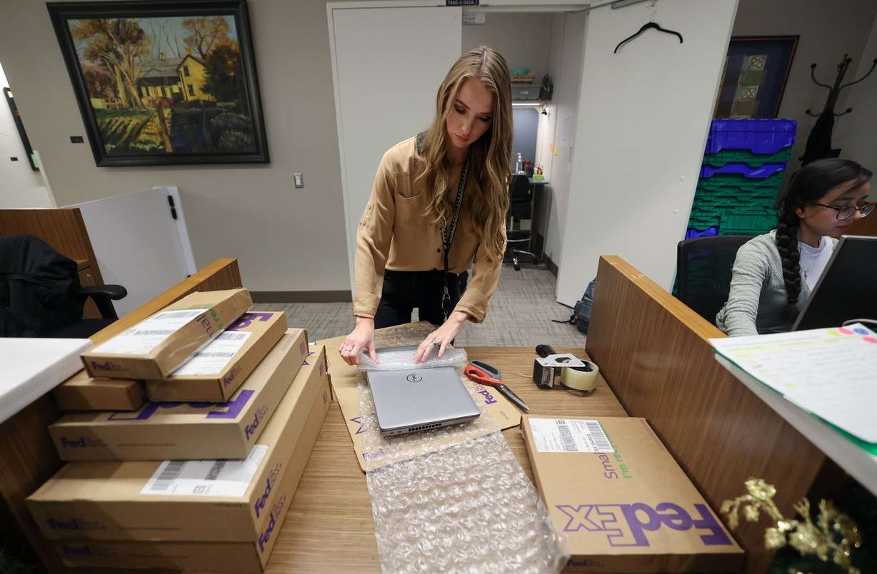 Nikki Rasmussen, Salt Lake City International Airport lost and found representative, wraps up a lost laptop to ship back to its owner at the lost and found at the Salt Lake City International Airport in Salt Lake City on Dec. 4.