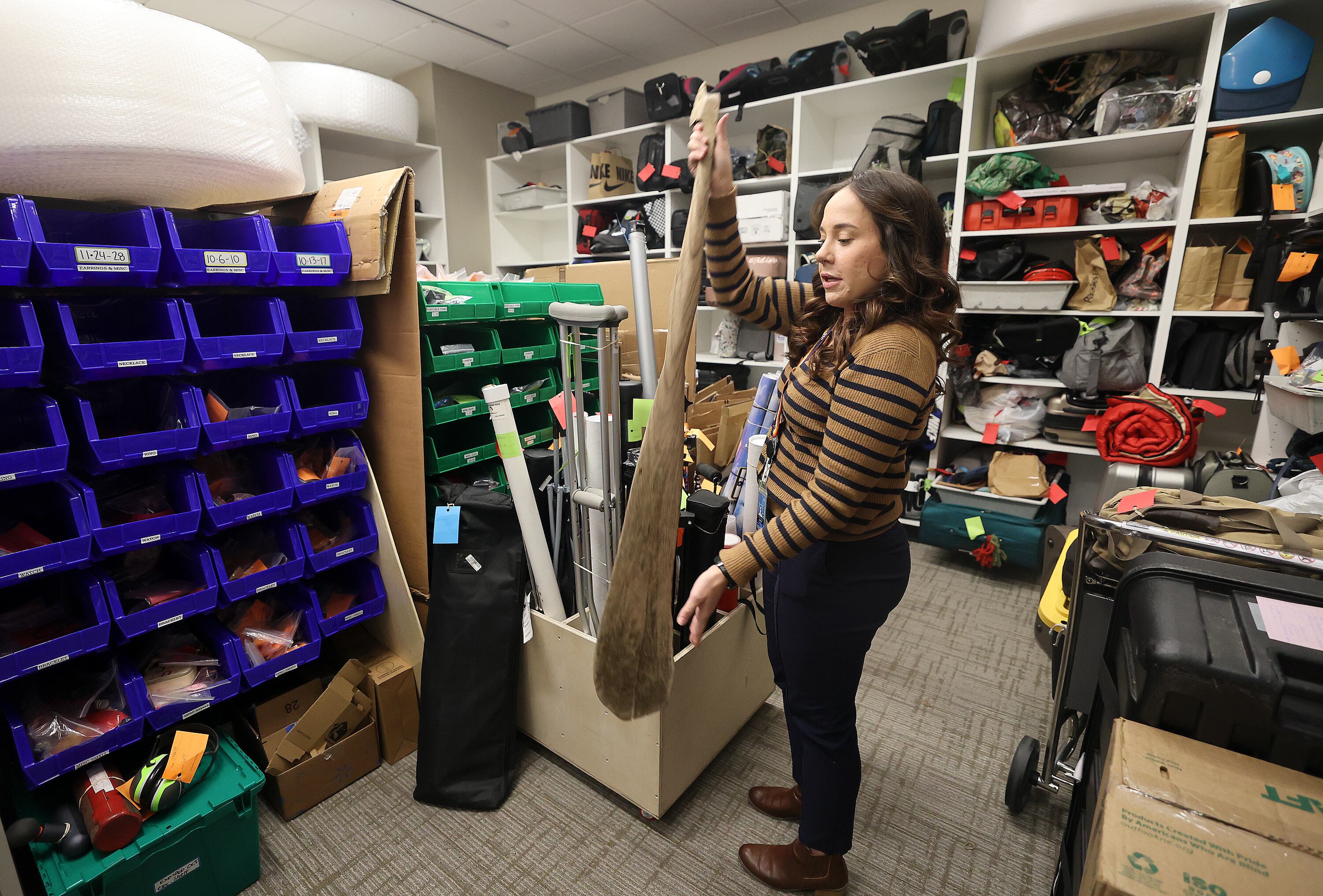 Melissa Royle, Salt Lake City International Airport customer service supervisor, shows an oar at the lost and found at the Salt Lake City International Airport in Salt Lake City on Dec. 4.