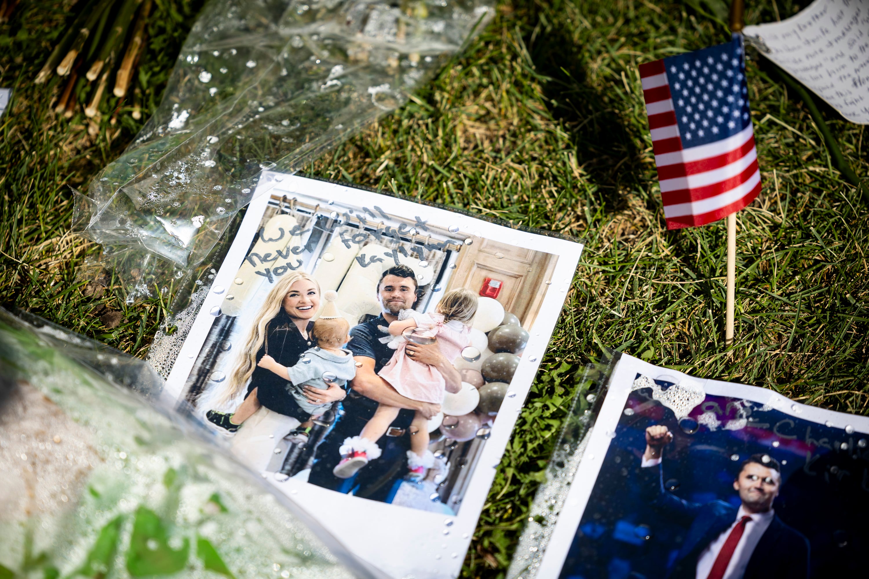 A photo of Charlie Kirk and his wife, Erika Kirk, with their children is displayed among other items in a memorial left by well-wishers in the courtyard on the campus of Utah Valley University in Orem on Sept. 17, as students returned to campus following the shooting death of Charlie Kirk in the courtyard a week prior. Erika Kirk called the conspiracy theories surrounding her husband's death "a mind virus."