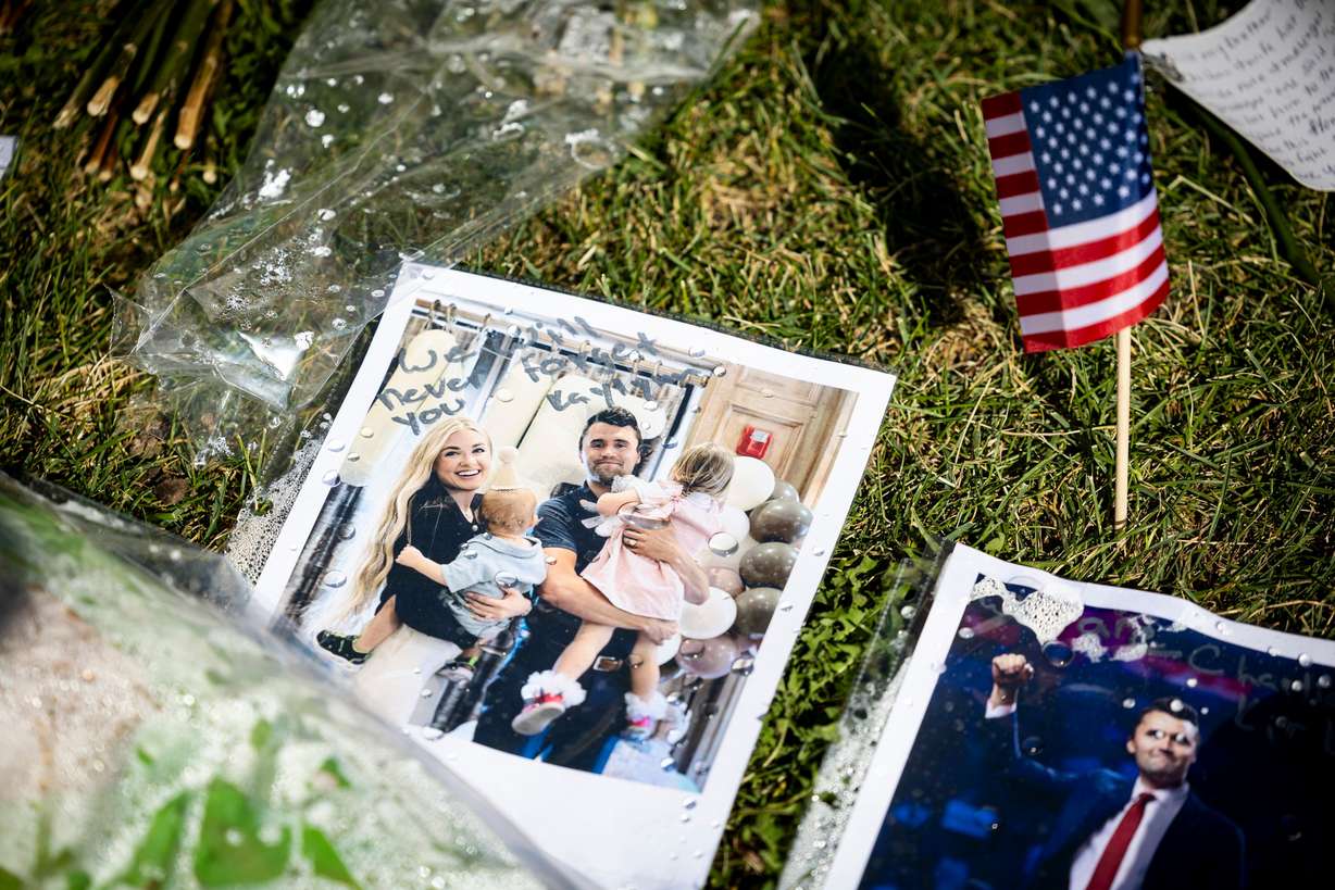 A photo of Charlie Kirk and his wife, Erika Kirk, with their children is displayed among other items in a memorial left by well-wishers in the courtyard on the campus of Utah Valley University in Orem on Sept. 17, as students returned to campus following the shooting death of Charlie Kirk in the courtyard a week prior. Erika Kirk called the conspiracy theories surrounding her husband's death "a mind virus."
