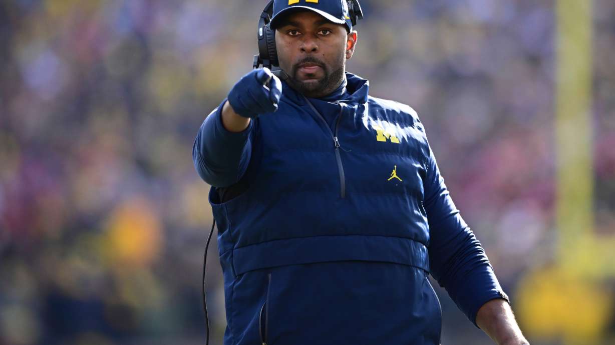 FILE - Michigan acting head coach Sherrone Moore reacts to a video replay during the first half of an NCAA college football game against Ohio State, Saturday, Nov. 25, 2023, in Ann Arbor, Mich.
