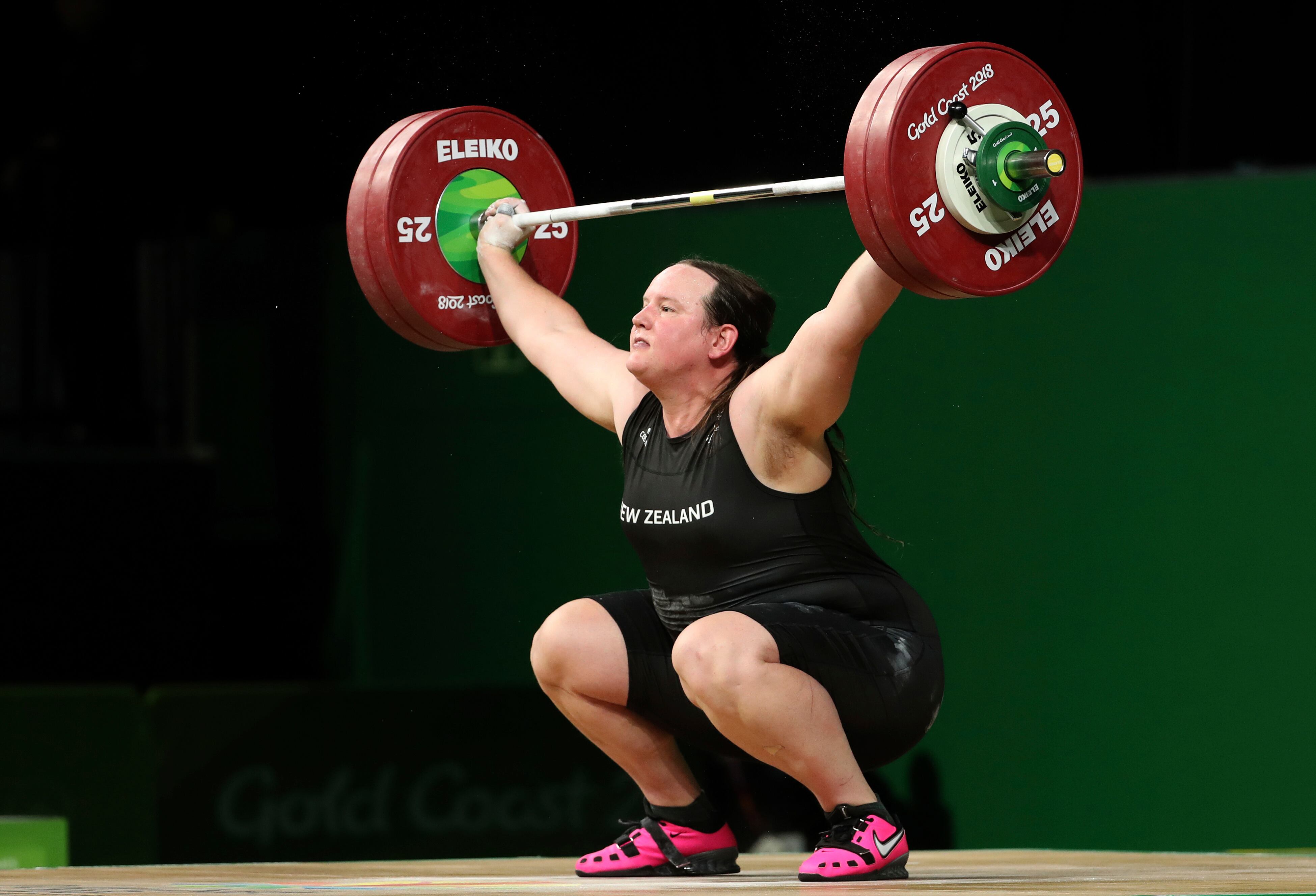 In this April 9, 2018 photo, New Zealand's Laurel Hubbard lifts in the women's +90kg weightlifting final at the 2018 Commonwealth Games on the Gold Coast, Australia. Selected to compete at the 2020 Summer Olympics, she was the first openly transgender woman to compete in the Olympic Games.