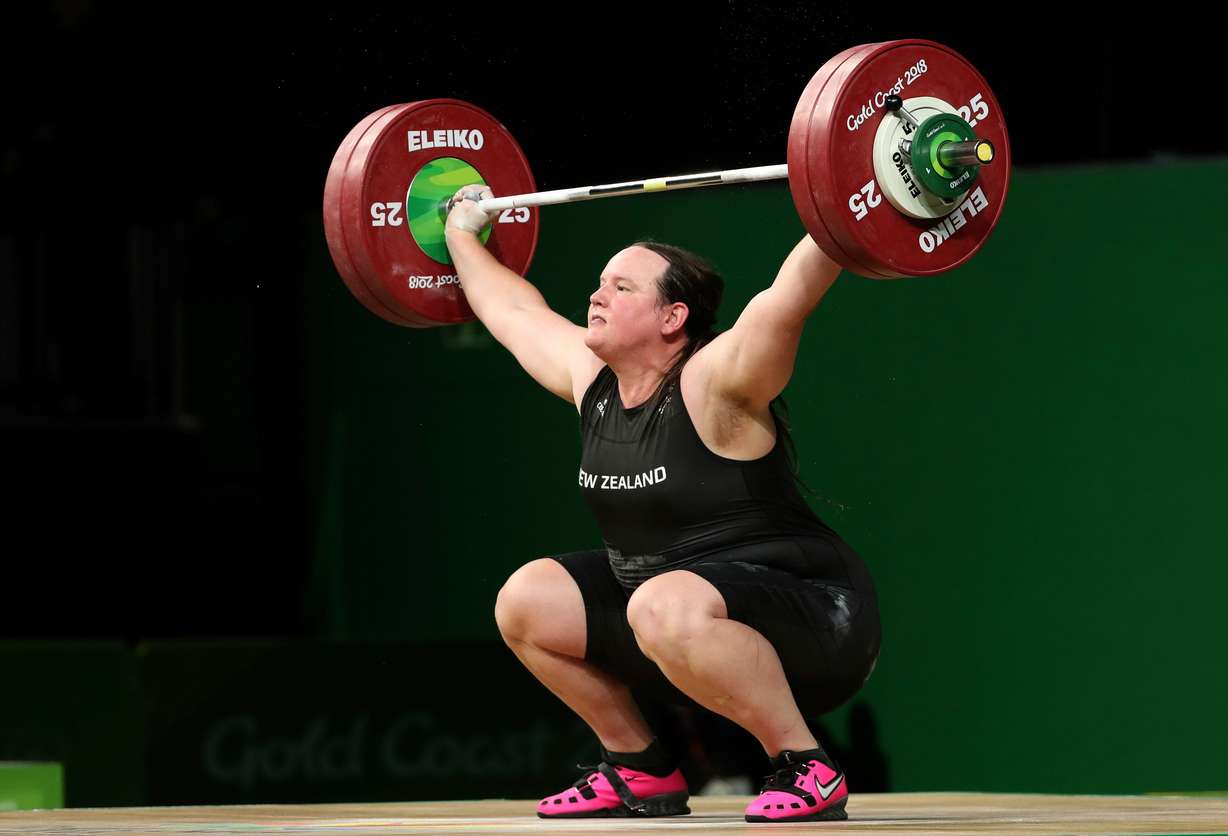 In this April 9, 2018 photo, New Zealand's Laurel Hubbard lifts in the women's +90kg weightlifting final at the 2018 Commonwealth Games on the Gold Coast, Australia. Selected to compete at the 2020 Summer Olympics, she was the first openly transgender woman to compete in the Olympic Games.