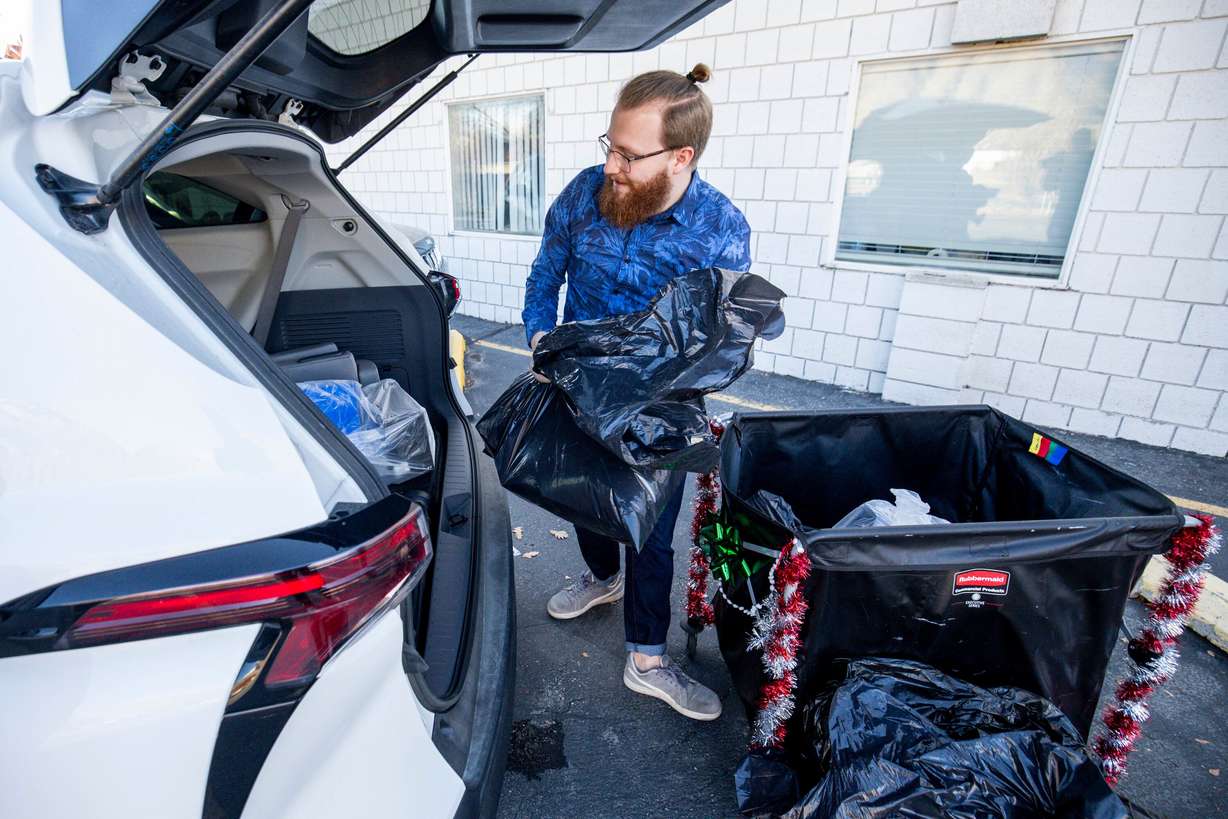 A volunteer from the Slate Canyon Youth Center loads Sub for Santa packages into a car for delivery at United Way Utah County in Provo on Thursday.