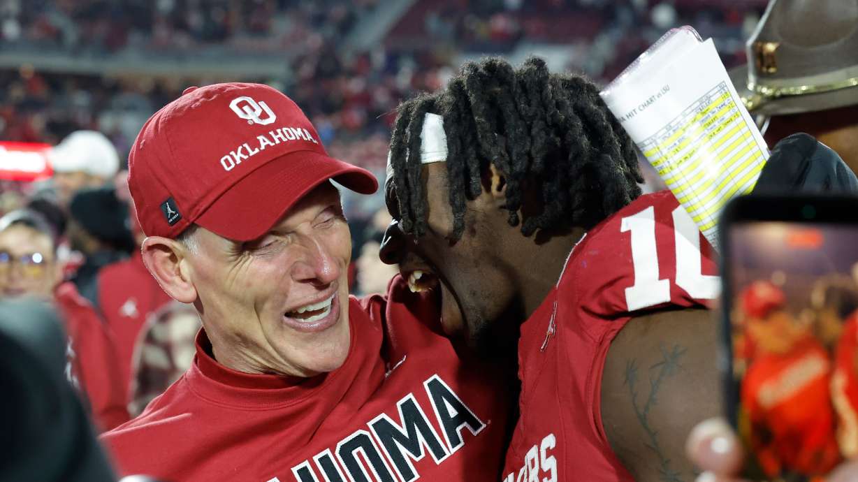 Oklahoma head coach Brent Venables celebrates with linebacker Kip Lewis (10) after defeating LSU during an NCAA college football game Saturday, Nov. 29, 2025, in Norman, Okla.