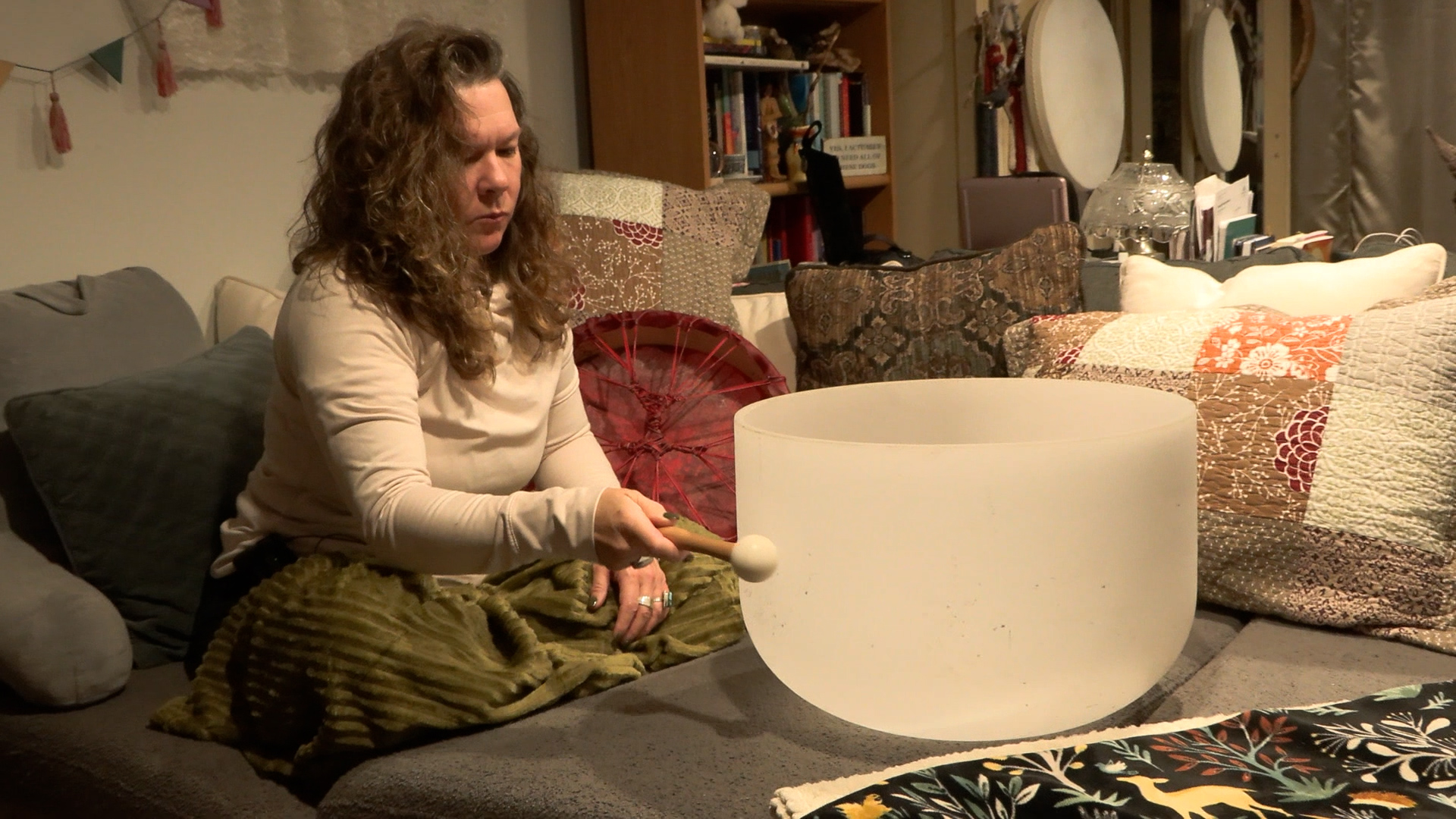 Shanti Neal of Millcreek does a sound healing exercise at her home, Thursday. Neal, a single mother, said caring for her well-being is essential this time of year.