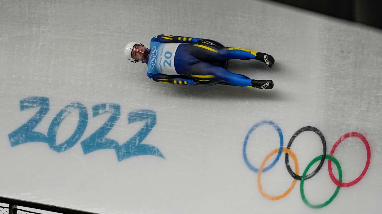 FILE -Anton Dukach, of Ukraine, slides during the luge men's single round 3 at the 2022 Winter Olympics, Feb. 6, 2022, in the Yanqing district of Beijing.