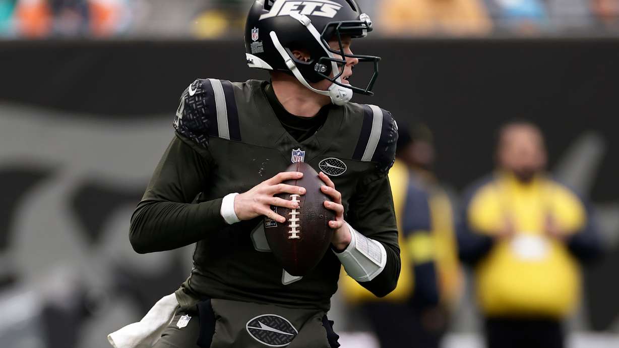 New York Jets quarterback Brady Cook (4) looks to pass against the Miami Dolphins during the second quarter of an NFL football game, Sunday, Dec. 7, 2025, in East Rutherford, N.J.
