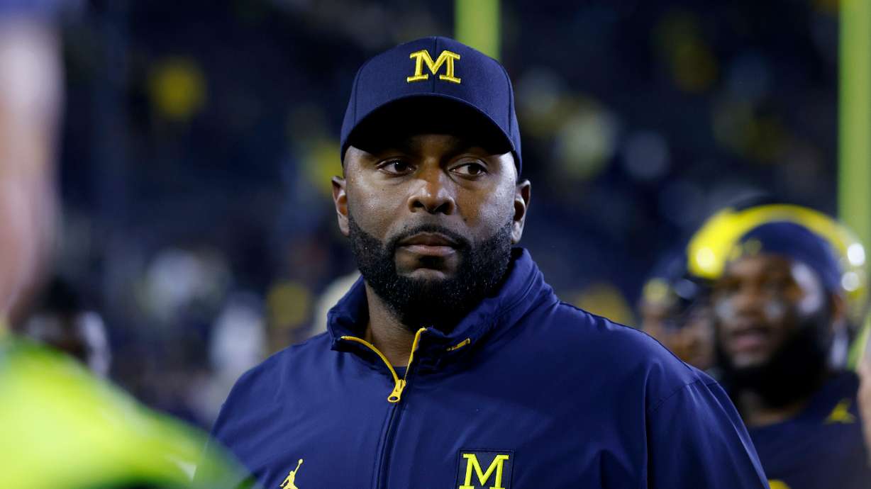 FILE - Michigan coach Sherrone Moore walks off the field following an NCAA football game on Saturday, Aug. 30, 2025, in Ann Arbor, Mich.