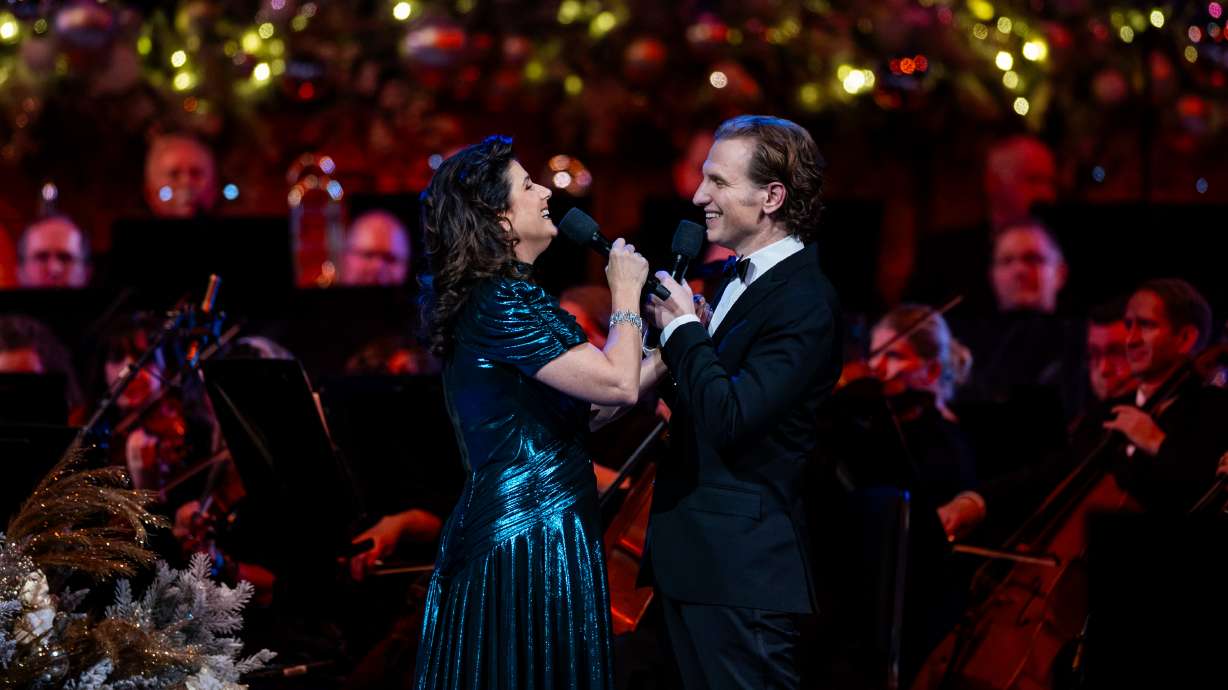 Stephanie J. Block and Sebastian Arcelus perform with the Tabernacle Choir at Temple Square during the Christmas concert at the Conference Center in Salt Lake City on Thursday.