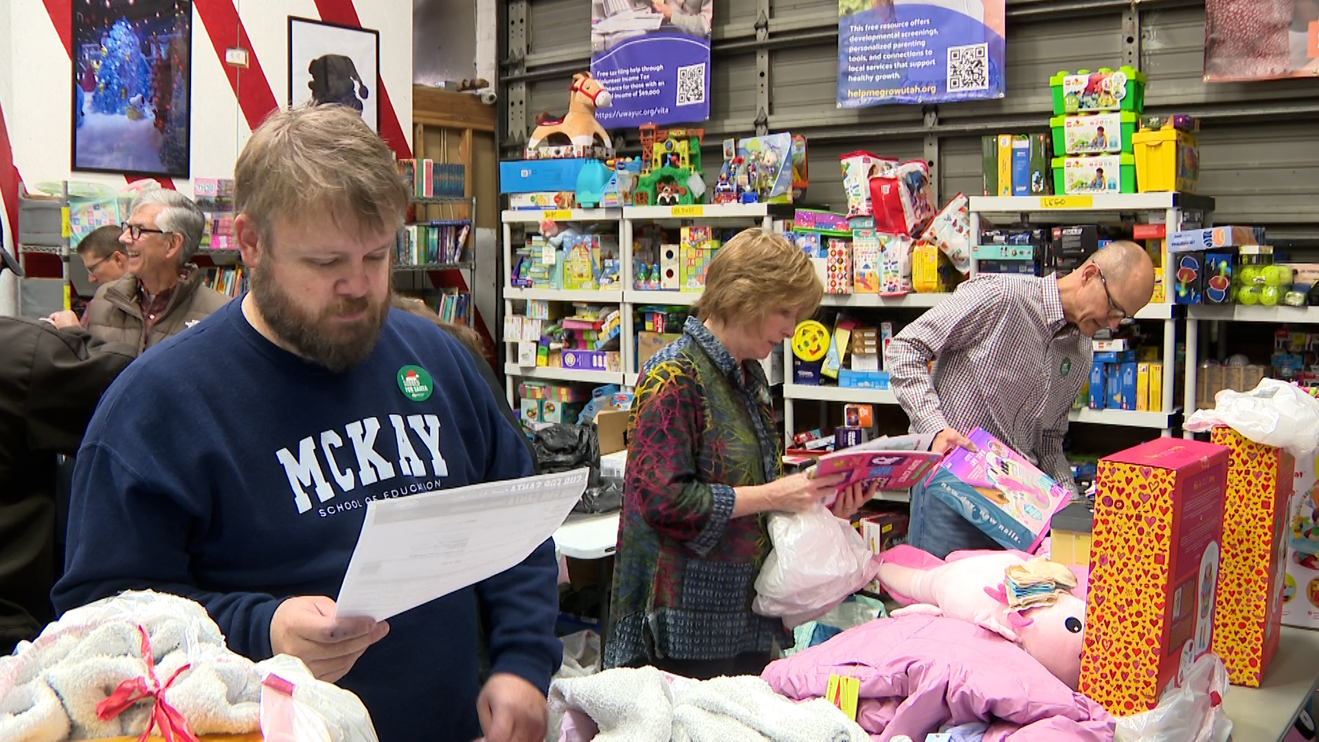 Volunteers from Brigham Young University work to assemble Sub for Santa gifts at a warehouse in Provo on Friday. United Way is seeing record need for donations this year for the program.