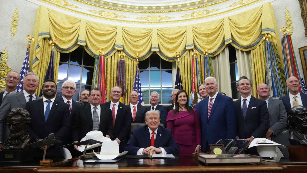 President Donald Trump attends a bill signing ceremony with members of the 1980 U.S. Men's Olympic Hockey team, Friday in the Oval Office of the White House in Washington.