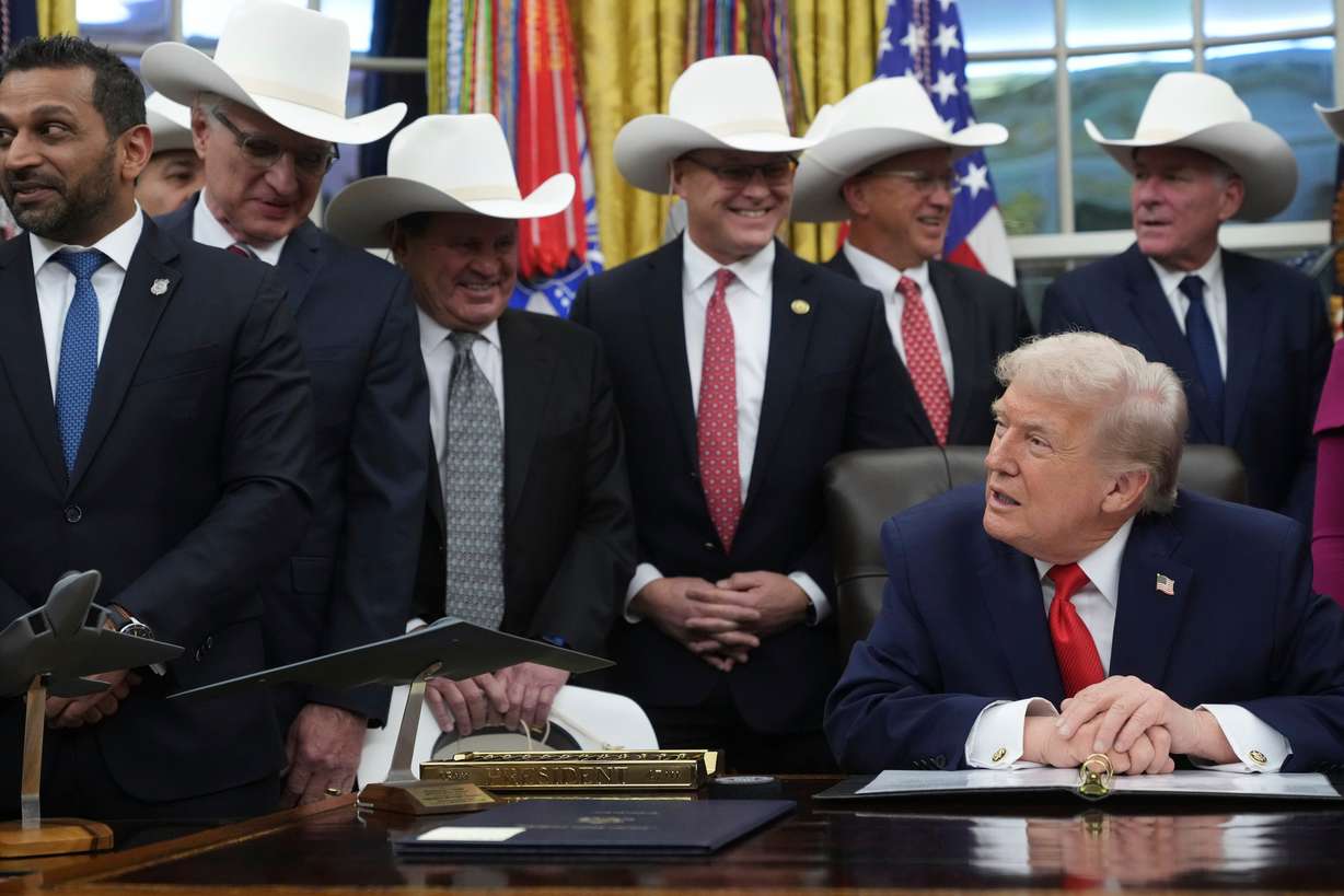 President Donald Trump attends a bill signing ceremony with members of the 1980 U.S. Men's Olympic Hockey team, Friday, Dec. 12, 2025, in the Oval Office of the White House in Washington.