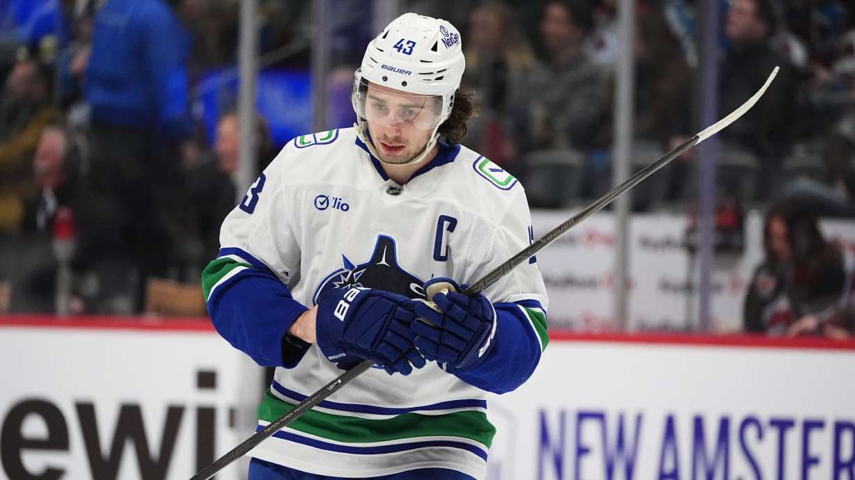 Vancouver Canucks defenseman Quinn Hughes waits for play to begin in the third period of an NHL hockey game against the Colorado Avalanche Tuesday, Dec. 2, 2025, in Denver.