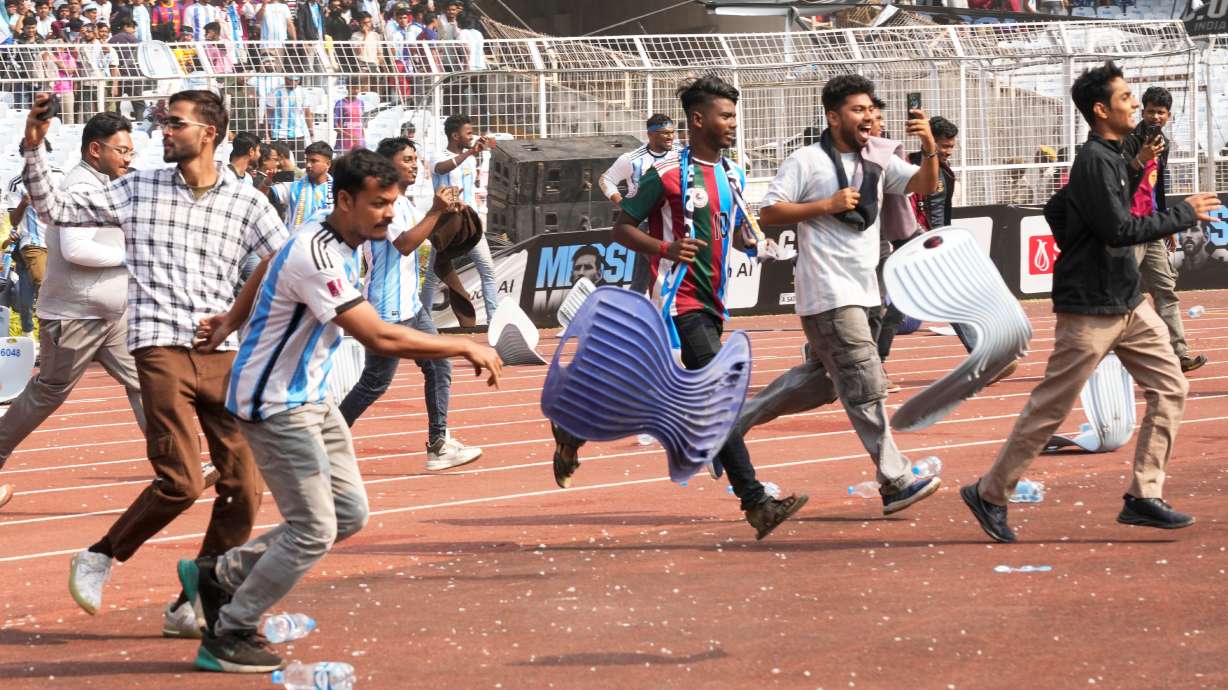 Indian fans vandalize stadium chairs as they run on to the field after failing to get a glimpse of Argentine soccer star Lionel Messi at the Salt Lake Stadium, in Kolkata, India, Saturday, Dec. 13, 2025.