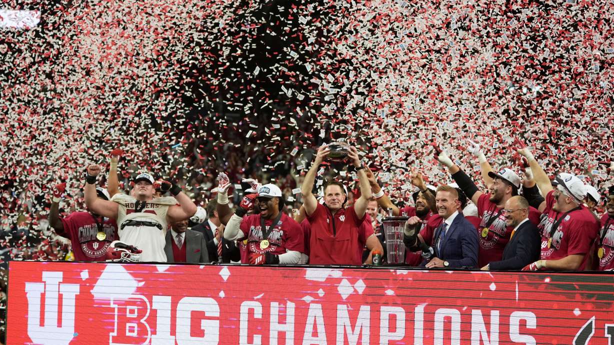 Indiana head coach Curt Cignetti holds the cahampionship trophy after the Big Ten championship NCAA college football game against Ohio State in Indianapolis, Saturday, Dec. 6, 2025.