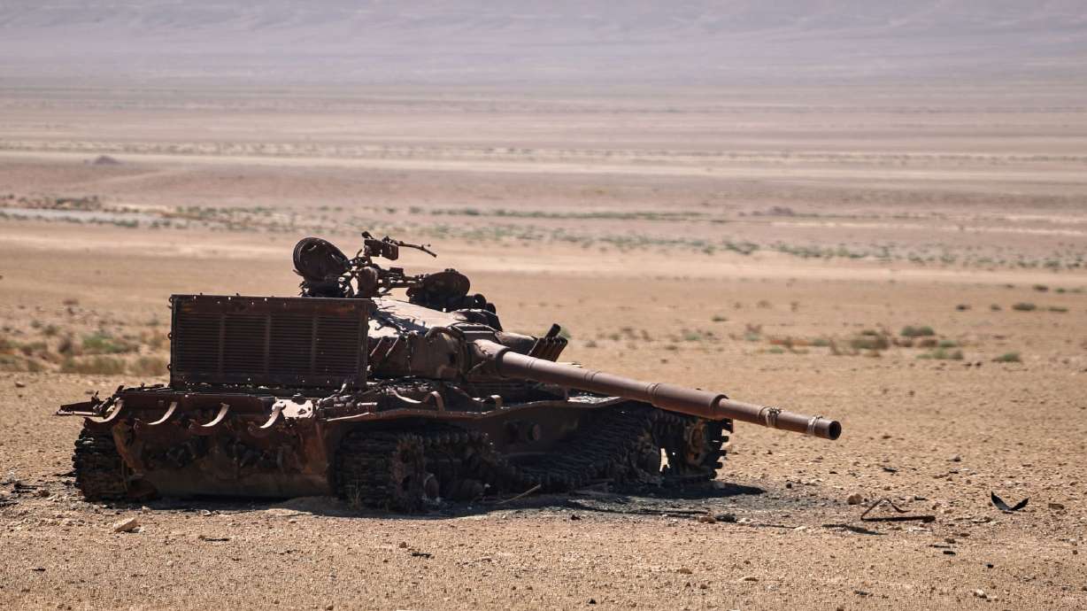 This file photo shows an abandoned, burned-out tank in the middle of a desert near the ancient city of Palmyra, Syria, Aug. 26.
