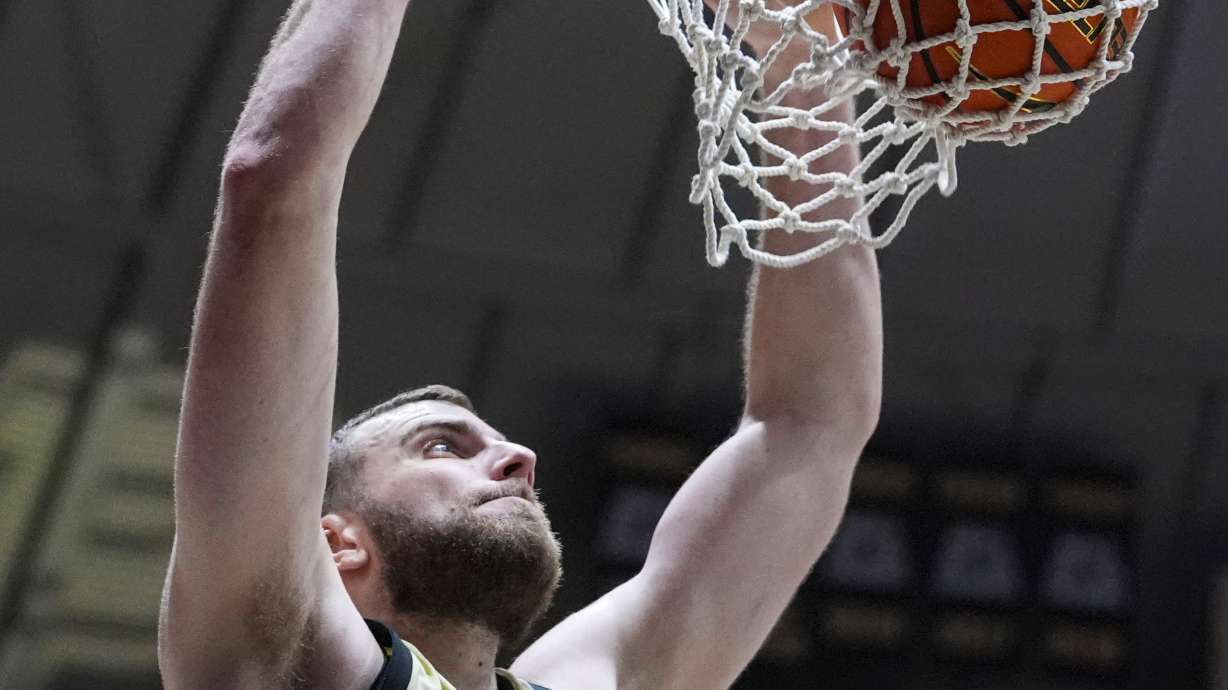 Purdue center Oscar Cluff (45) gets a basket on a dunk against Marquette during the second half of an NCAA college basketball game in West Lafayette, Ind., Saturday, Dec. 13, 2025.