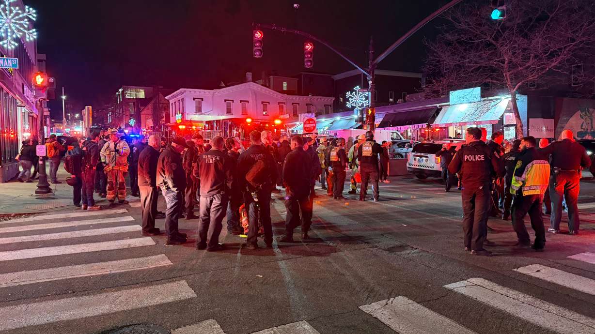 Police officers and first responders gather at Waterman Street and Thayer in response to a shooting at Brown University, in Providence, R.I., Saturday. Authorities say at least two people have been killed and eight are in critical condition.